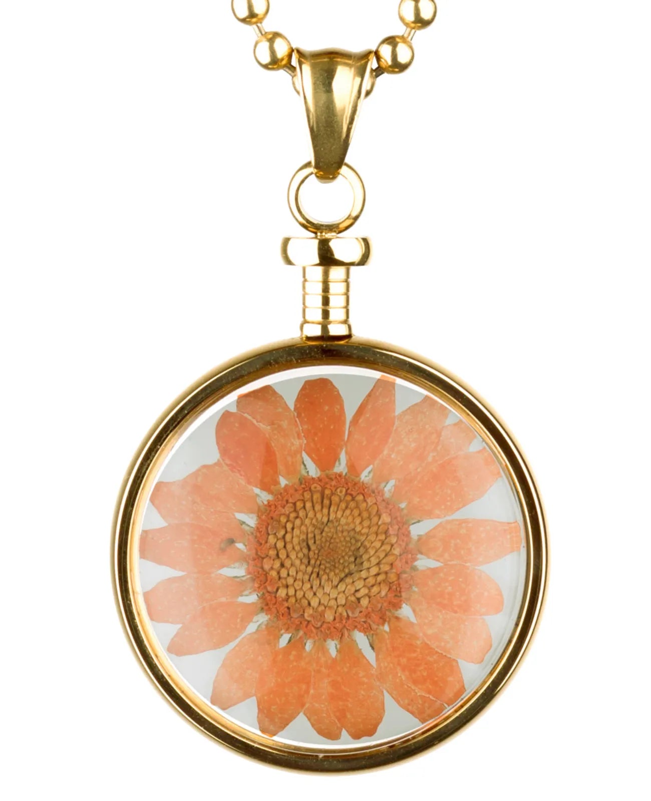 goldfarbener anhänger mit orangener blume hinter glas